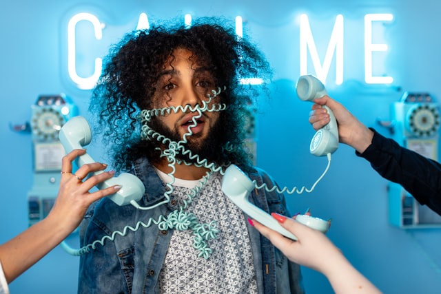 stressed person wrapped in telephone cords