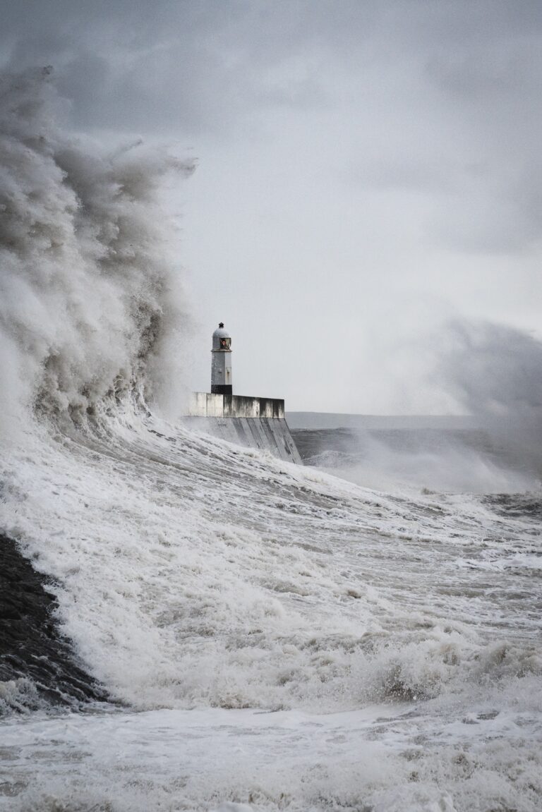 Ocean storm with lighthouse in background